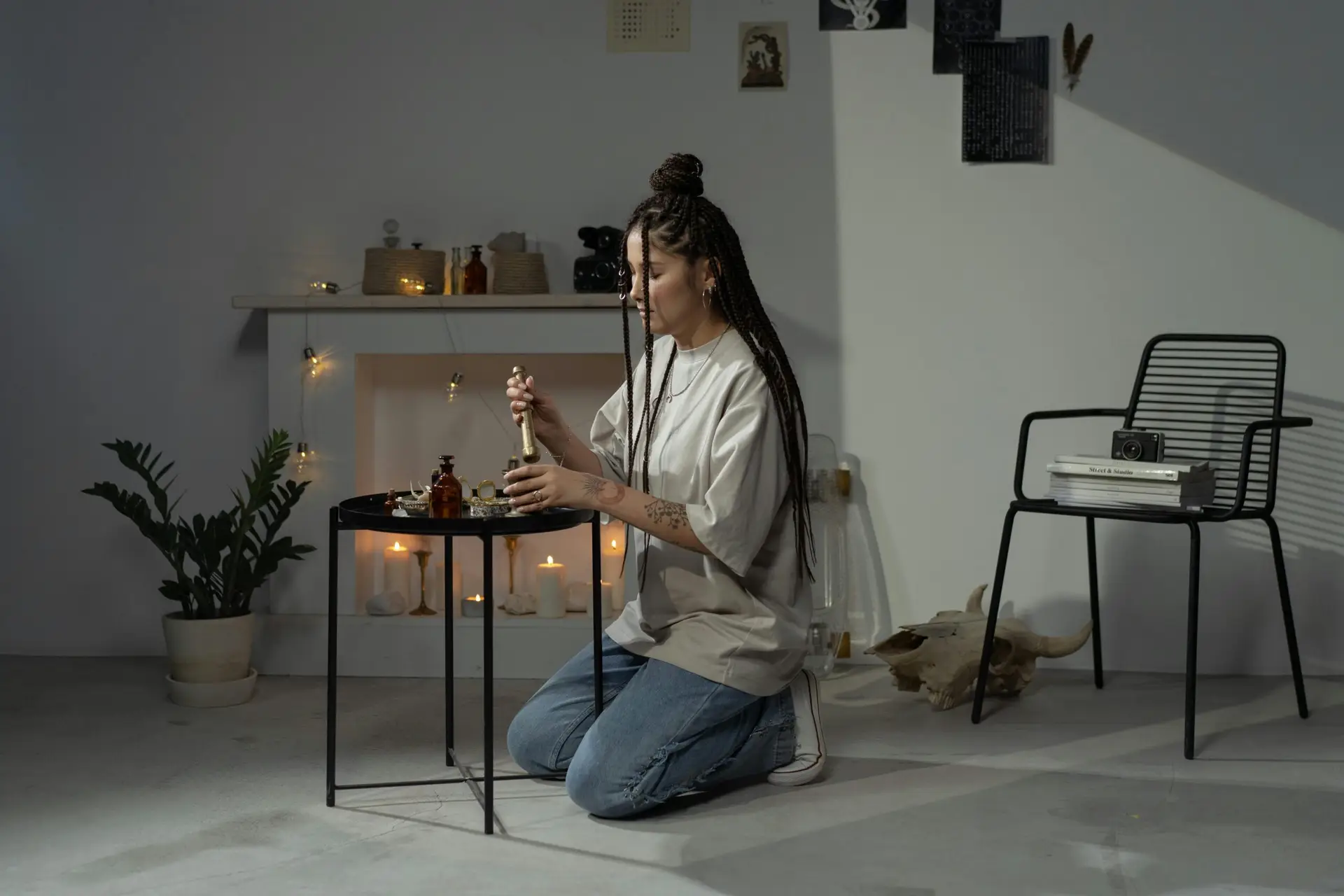 A young woman with braided hair engaged in witchcraft in a stylish home interior